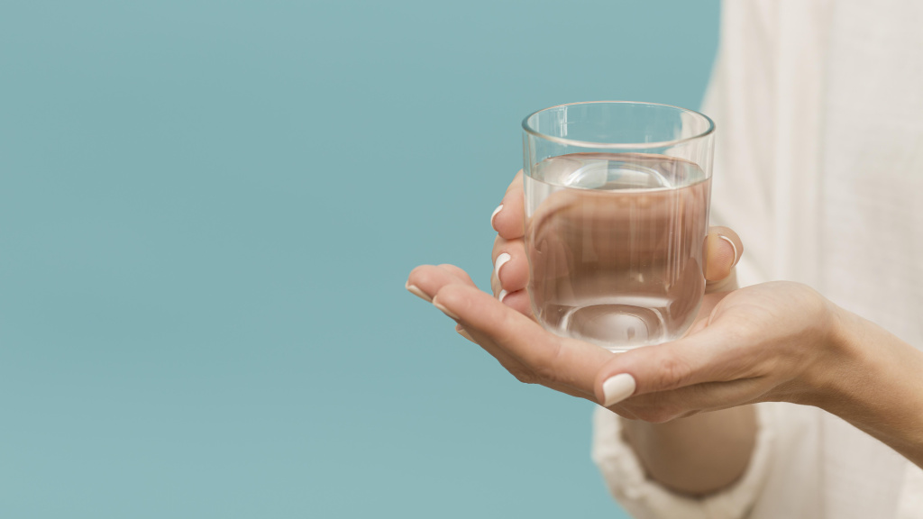 woman-holding-glass-filled-with-water-copy-space.jpg